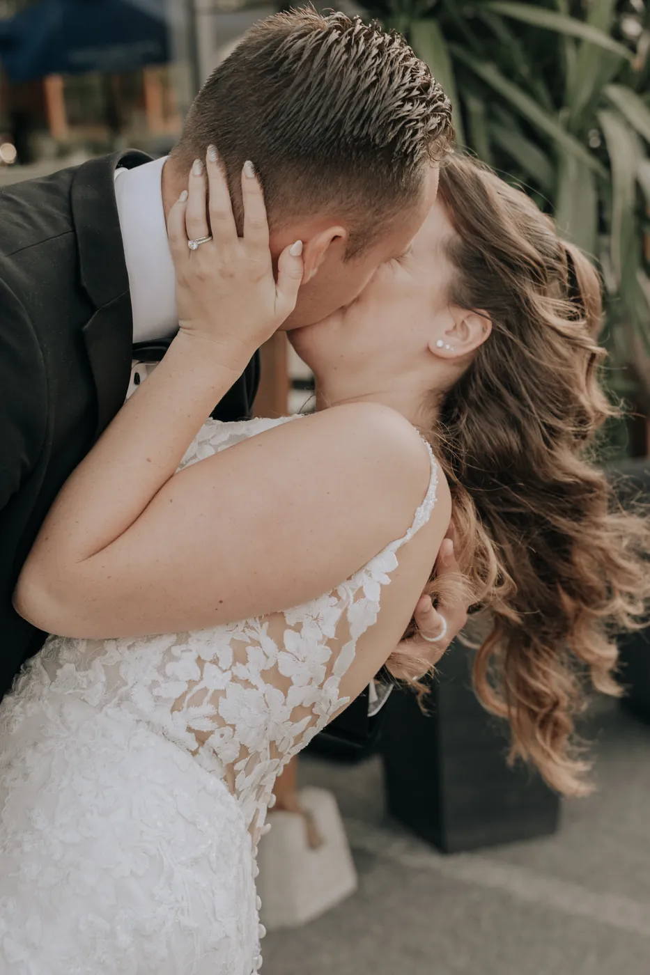 A bride and groom in a close embrace.